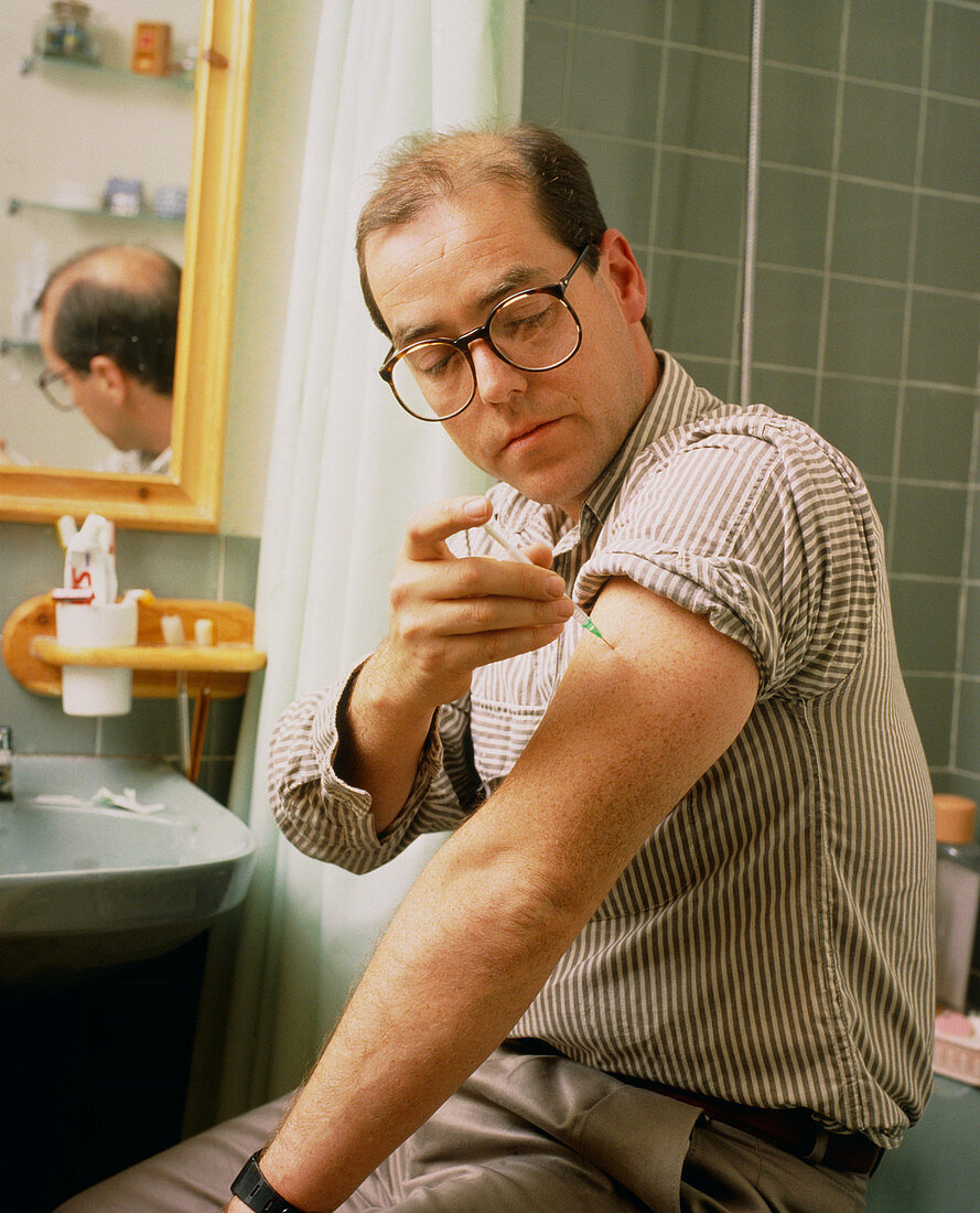 Diabetic injecting himself with insulin