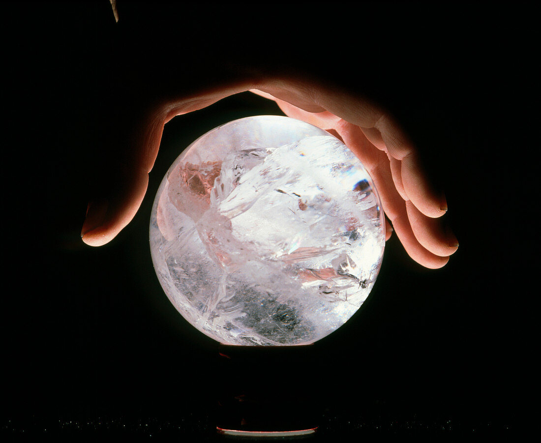 Crystal therapy: rock crystal sphere in man's hand