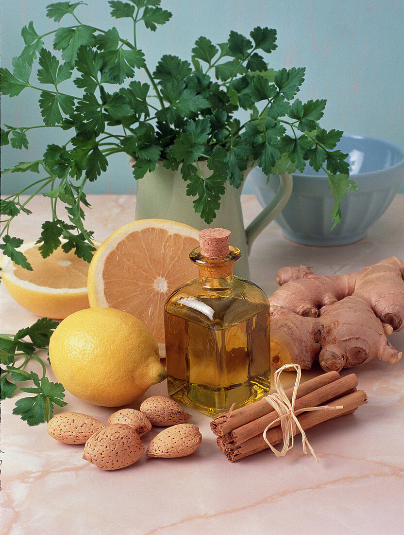 Bottle of aromatherapy oil surrounded by herbs