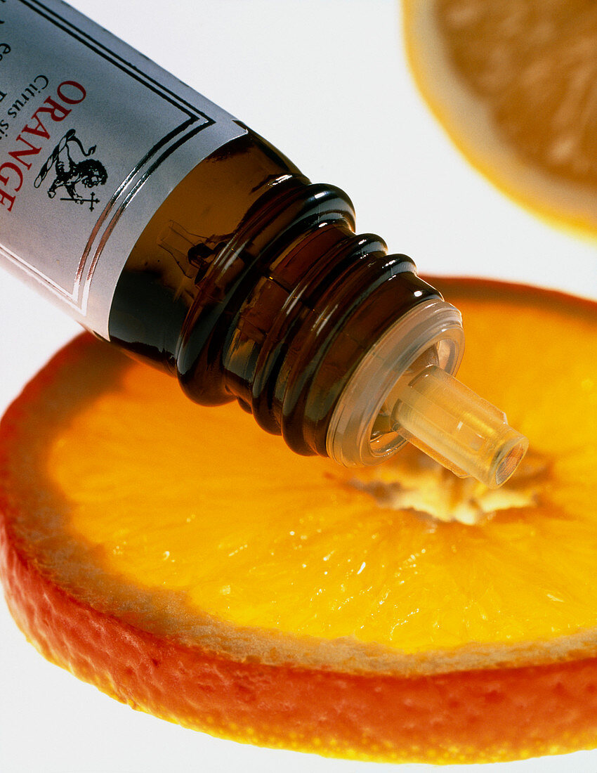 Orange slice and orange aromatherapy oil bottle