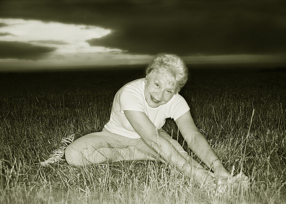 Elderly woman doing yoga exercises