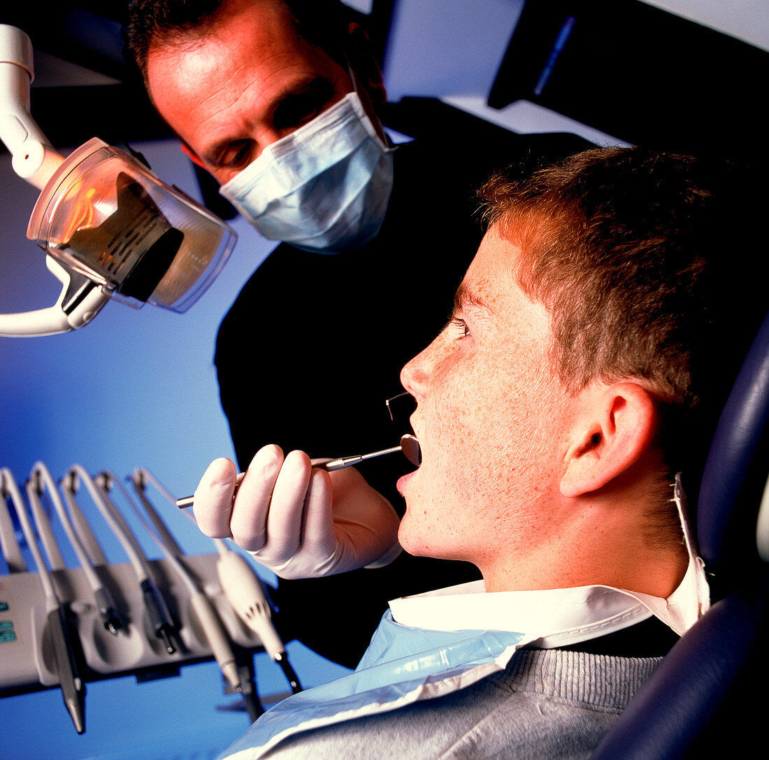 Dentist examining a boy's mouth