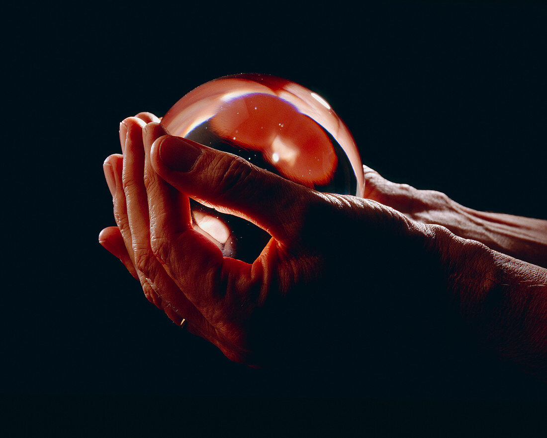 Hands holding a crystal ball