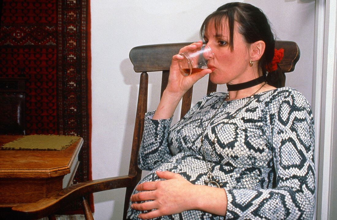 Pregnant woman having an alcoholic drink