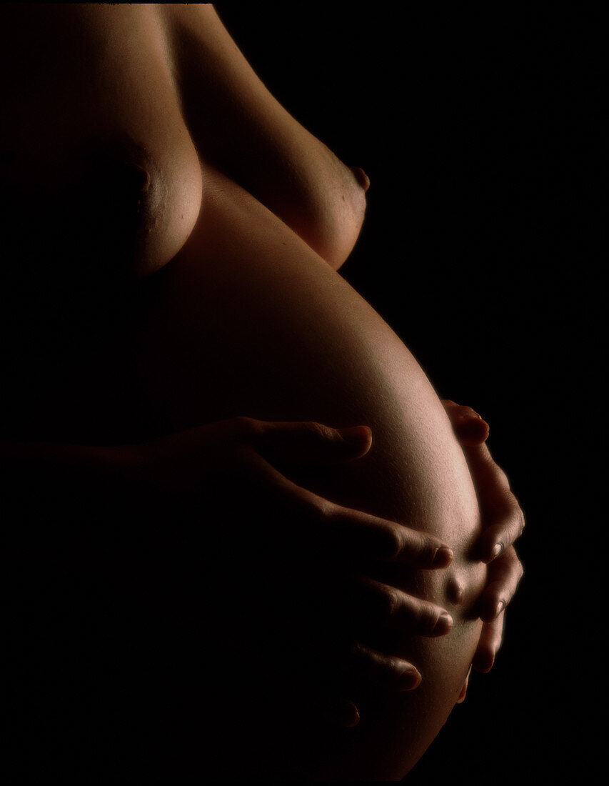 Naked abdomen of a pregnant woman at full-term