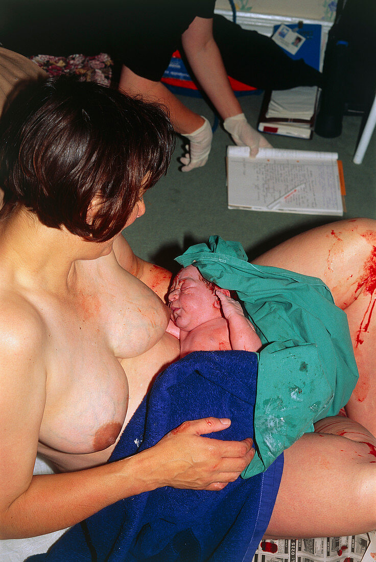 Natural childbirth: mother having just given birth