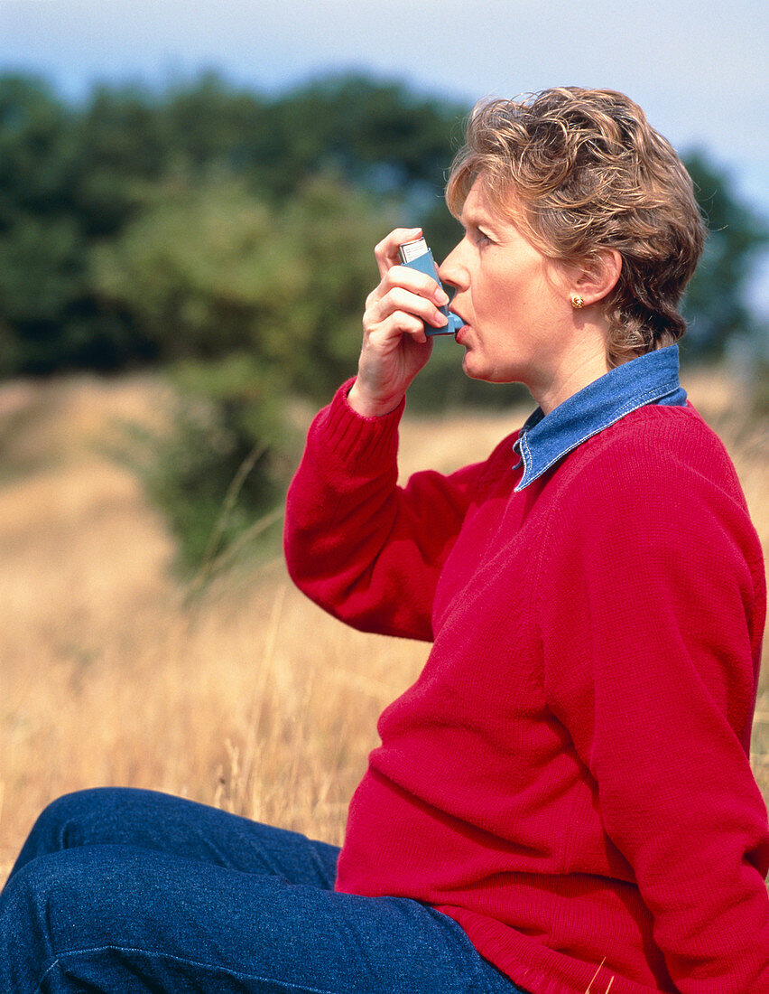 Pregnant woman using an inhaler to control asthma