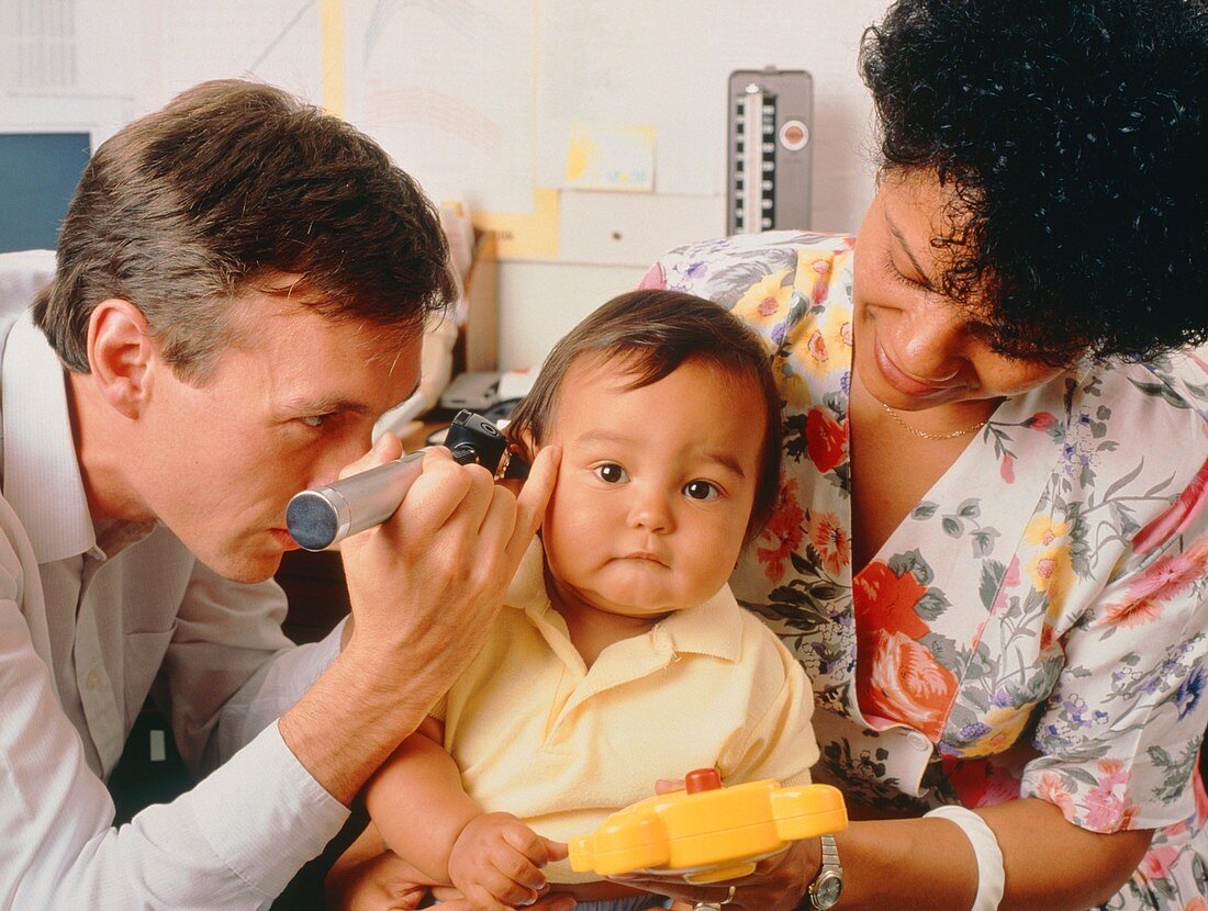 GP examining baby's ear