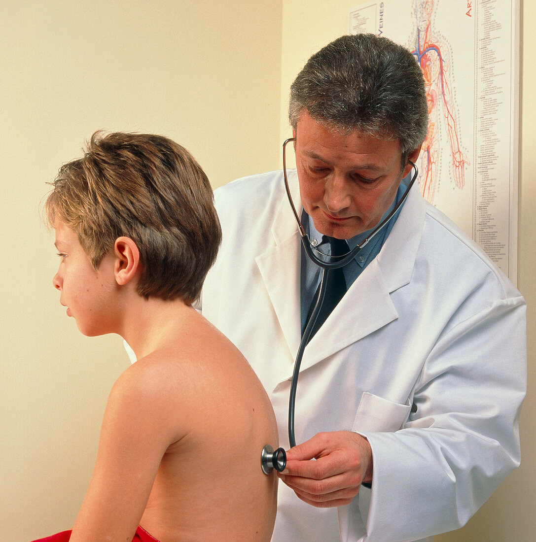 Doctor examines boy's chest with a stethoscope