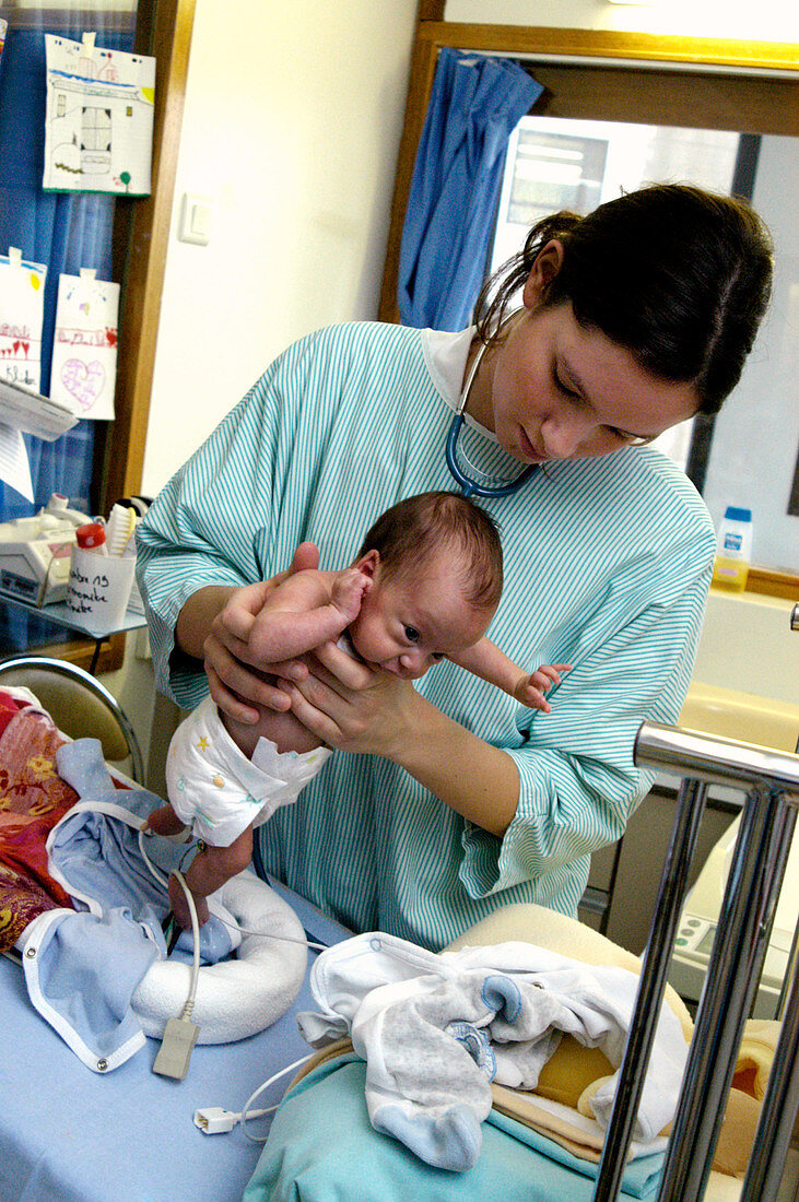 Doctor examining a premature baby