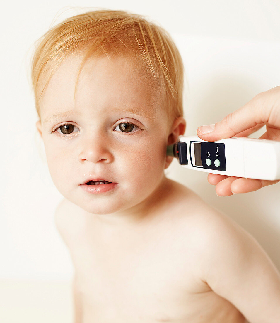 Boy having temperature taken