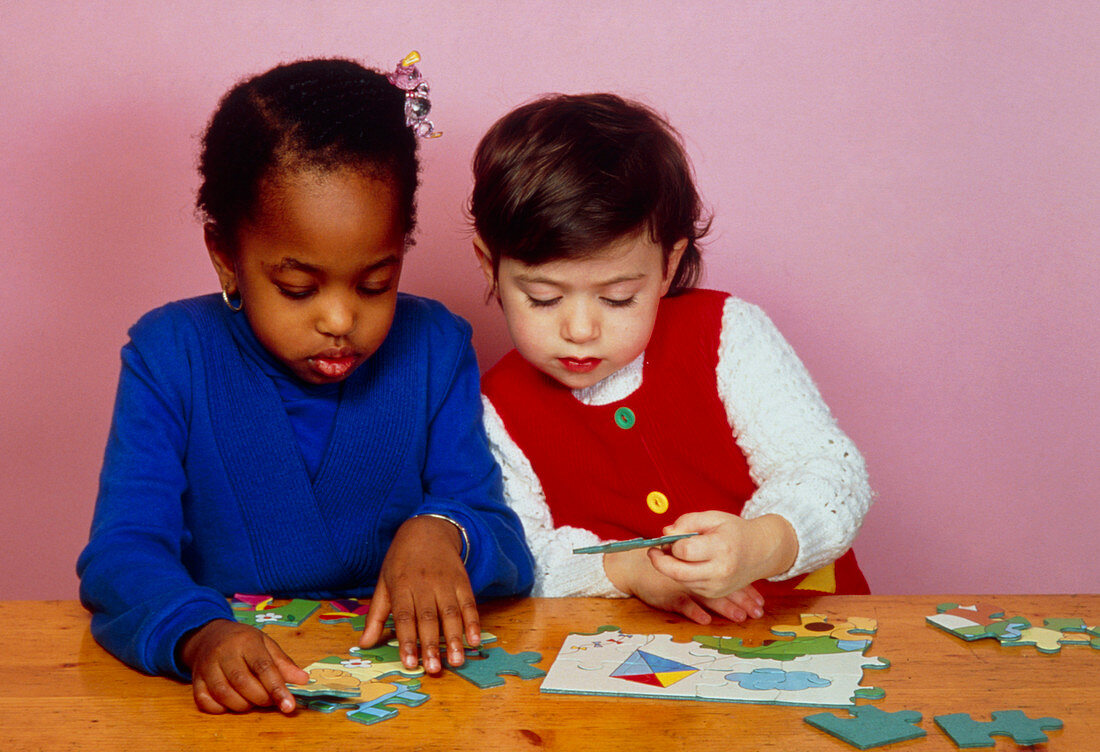 Young children playing with jigsaws