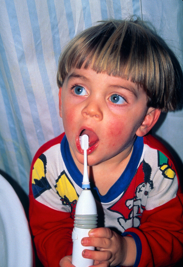 Young boy (two year old) brushing his teeth