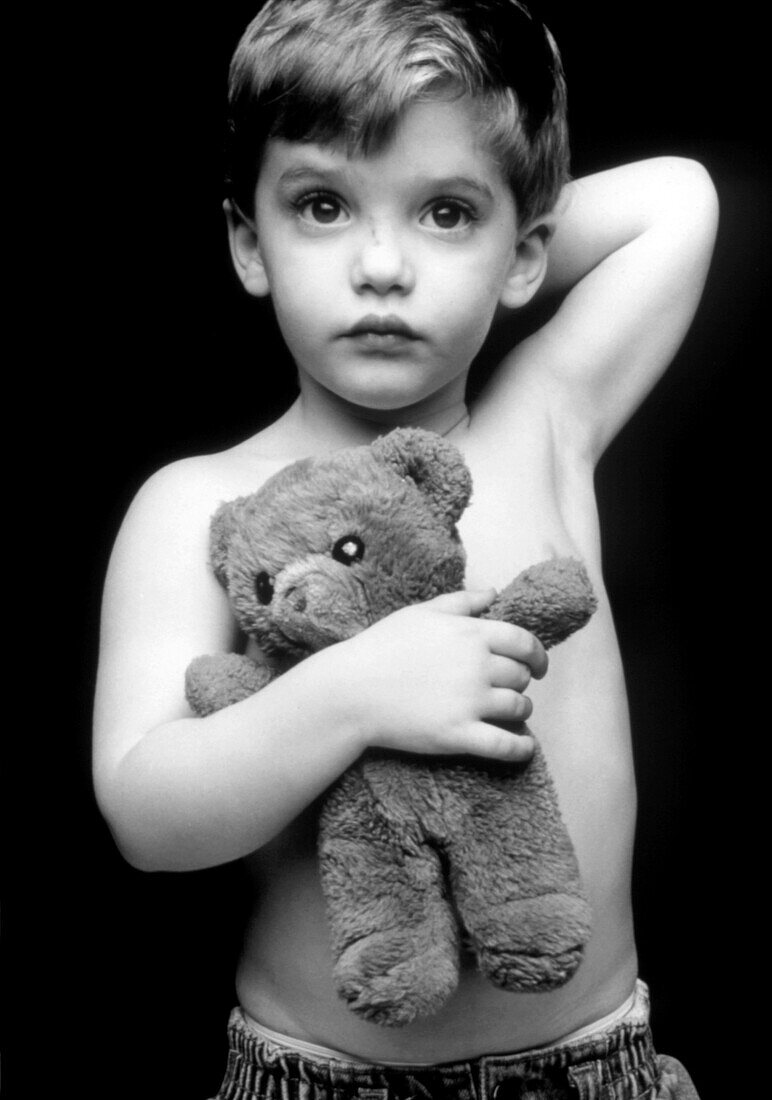 Three-year-old boy with his teddy bear toy