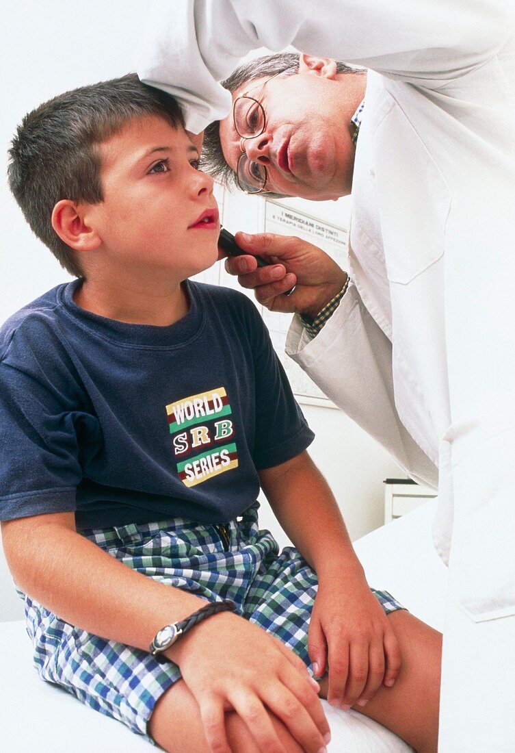 Doctor using an otoscope to examine a child's ear