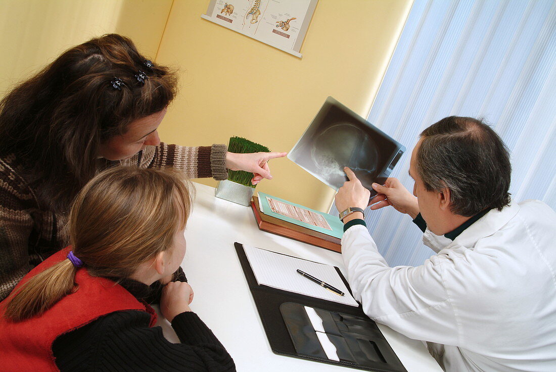 GP examining X-ray