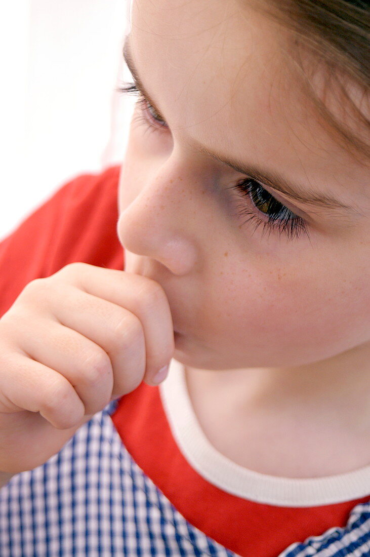 Young girl sucking her thumb