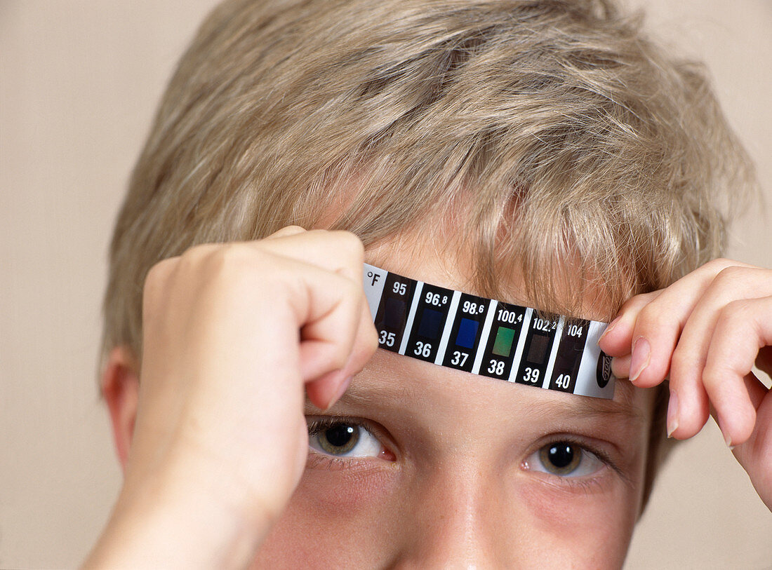 Boy measuring his temperature