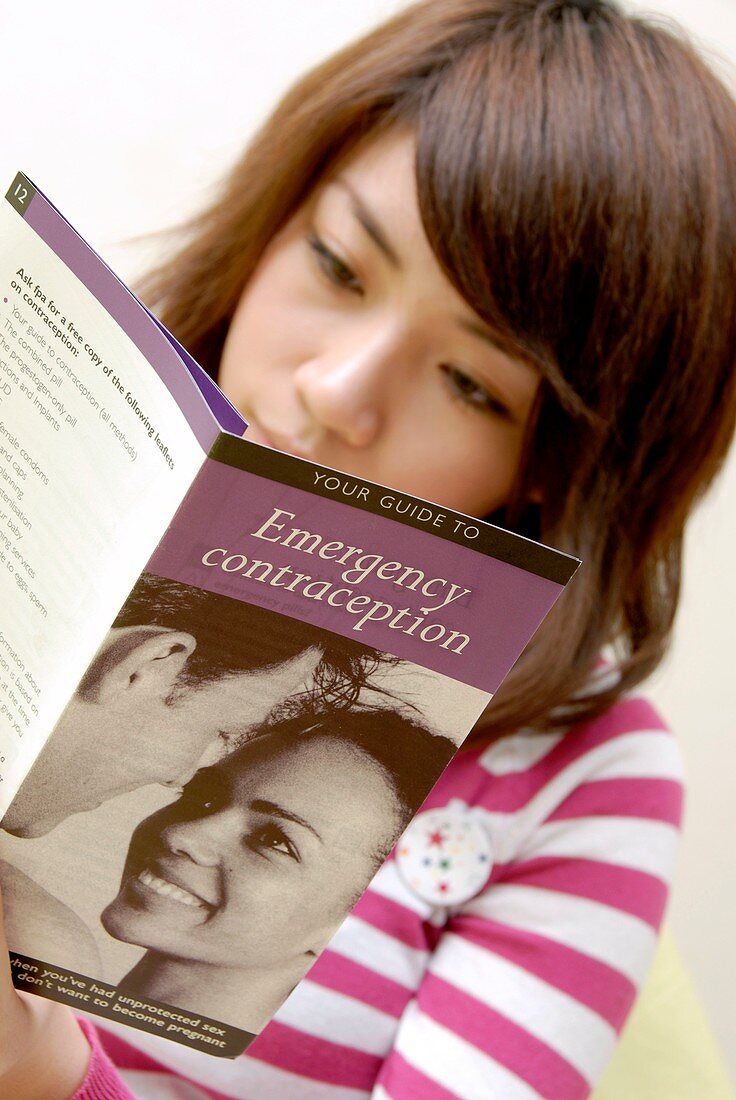 Woman reading contraception information