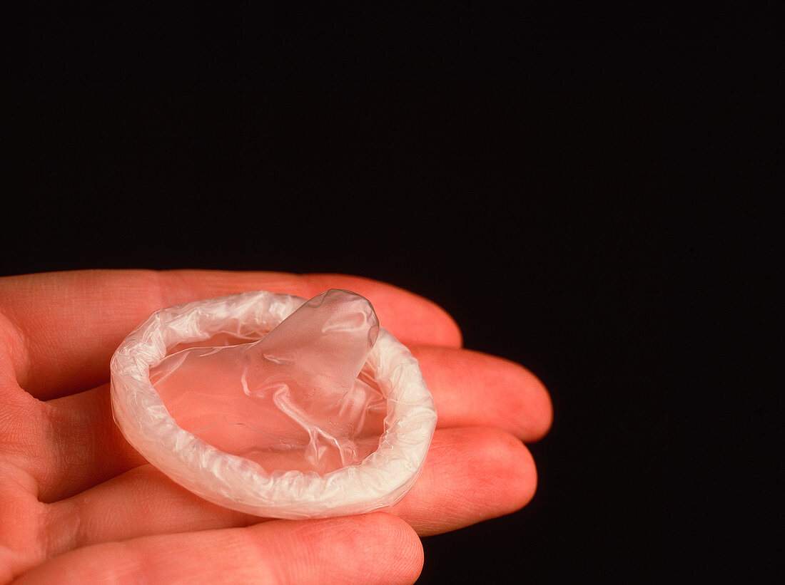 Latex-free hypo-allergenic male condom on a hand