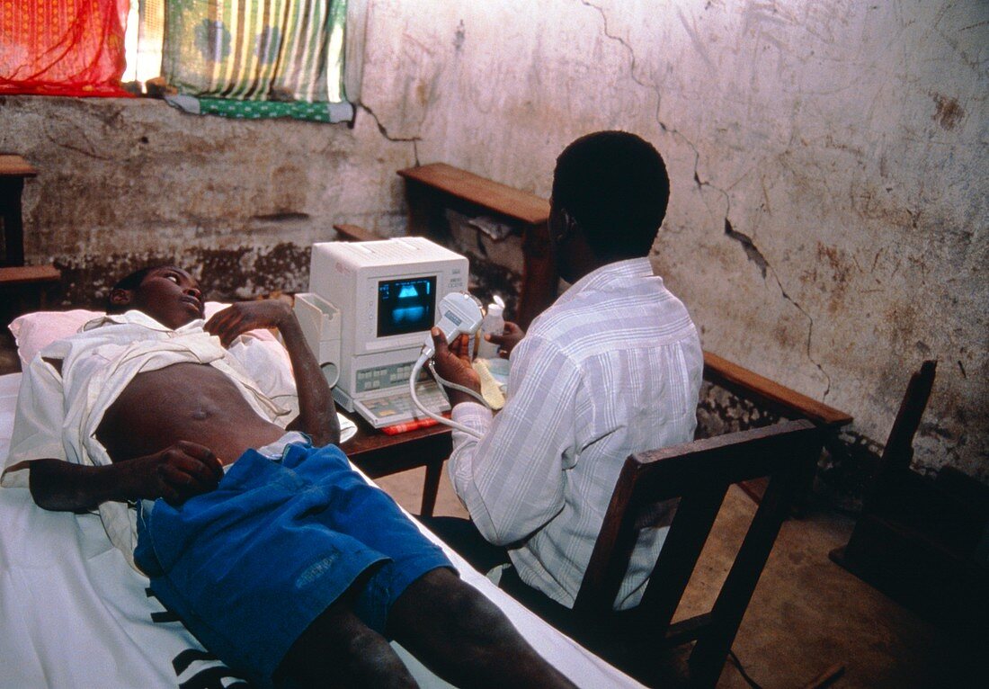 Health worker using portable ultrasound machine