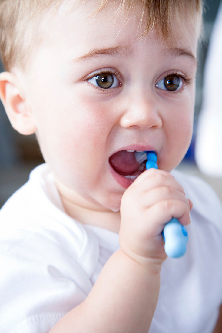 Young boy brushing his teeth