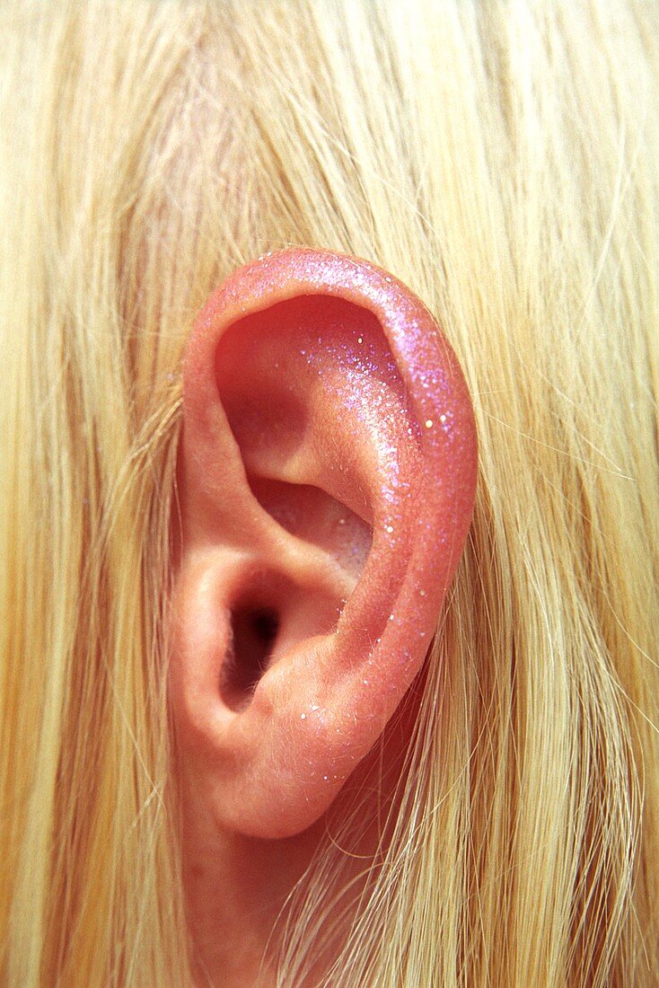 Woman's ear with glitter