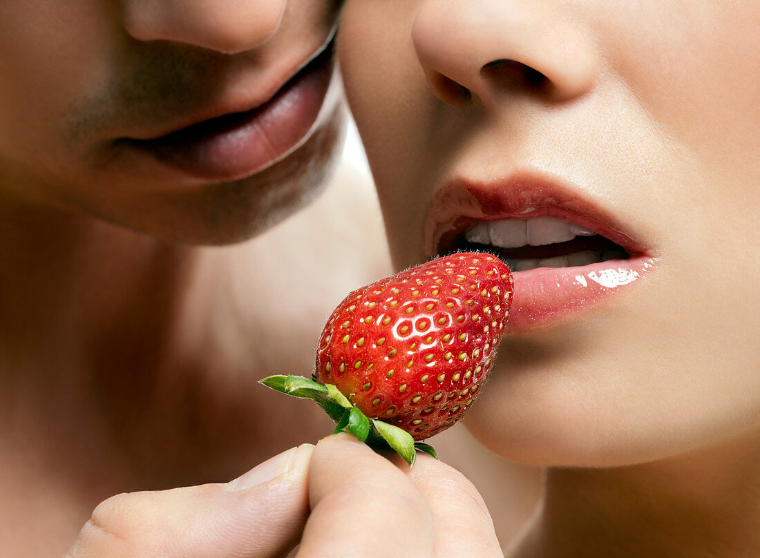 Lovers eating strawberries