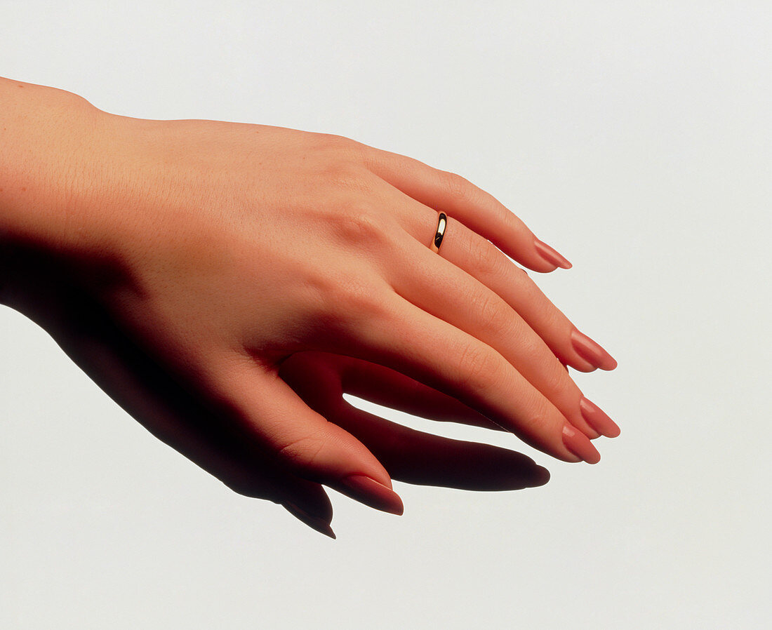 Woman's manicured hand with polished fingernails
