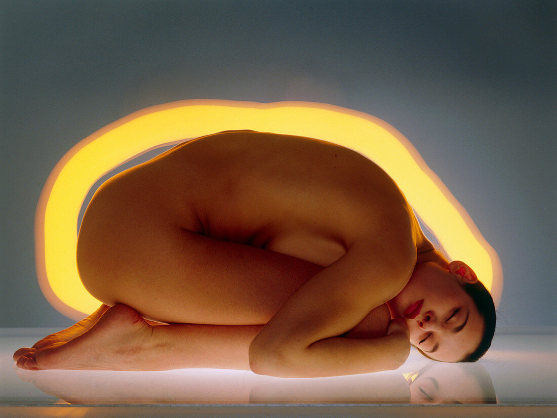 Woman's body surrounded by yellow glow
