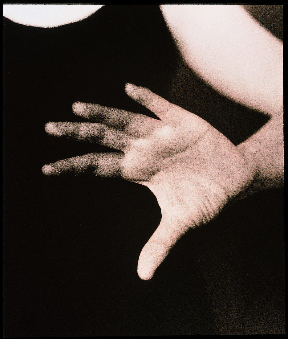 Hand of a woman held out,palm-facing for