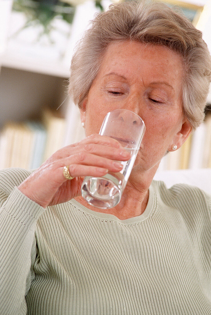 Elderly woman drinking water