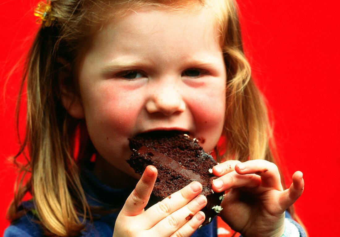 Young girl eating cake