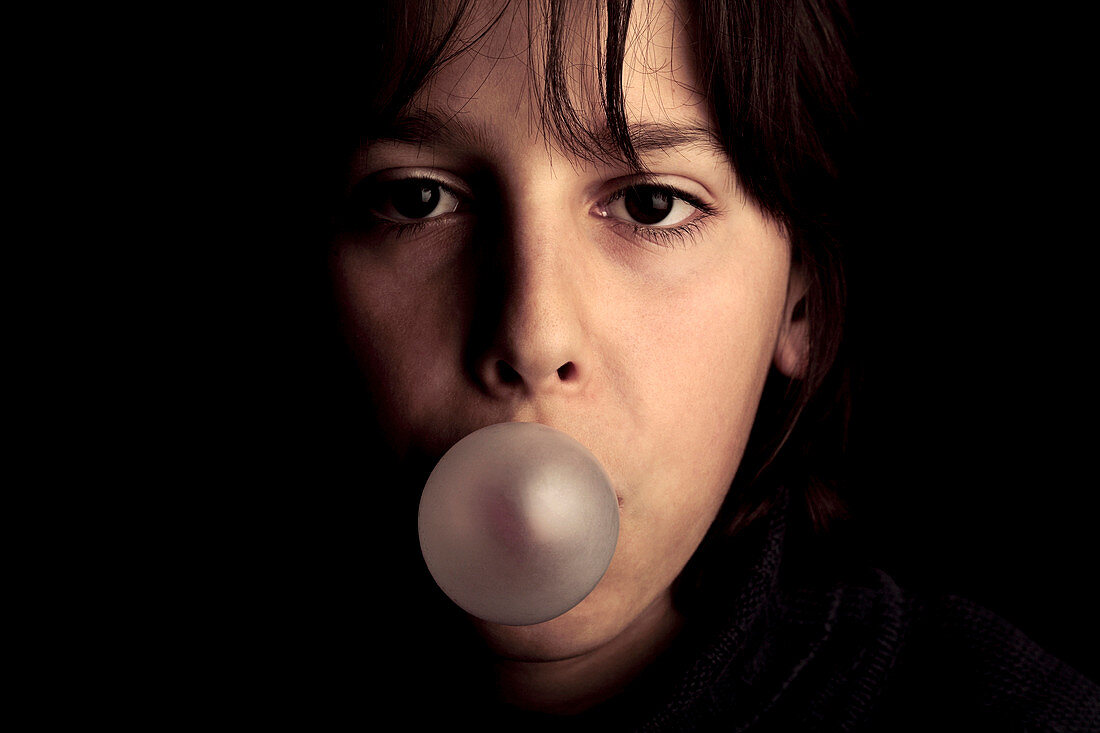 Boy blowing bubblegum