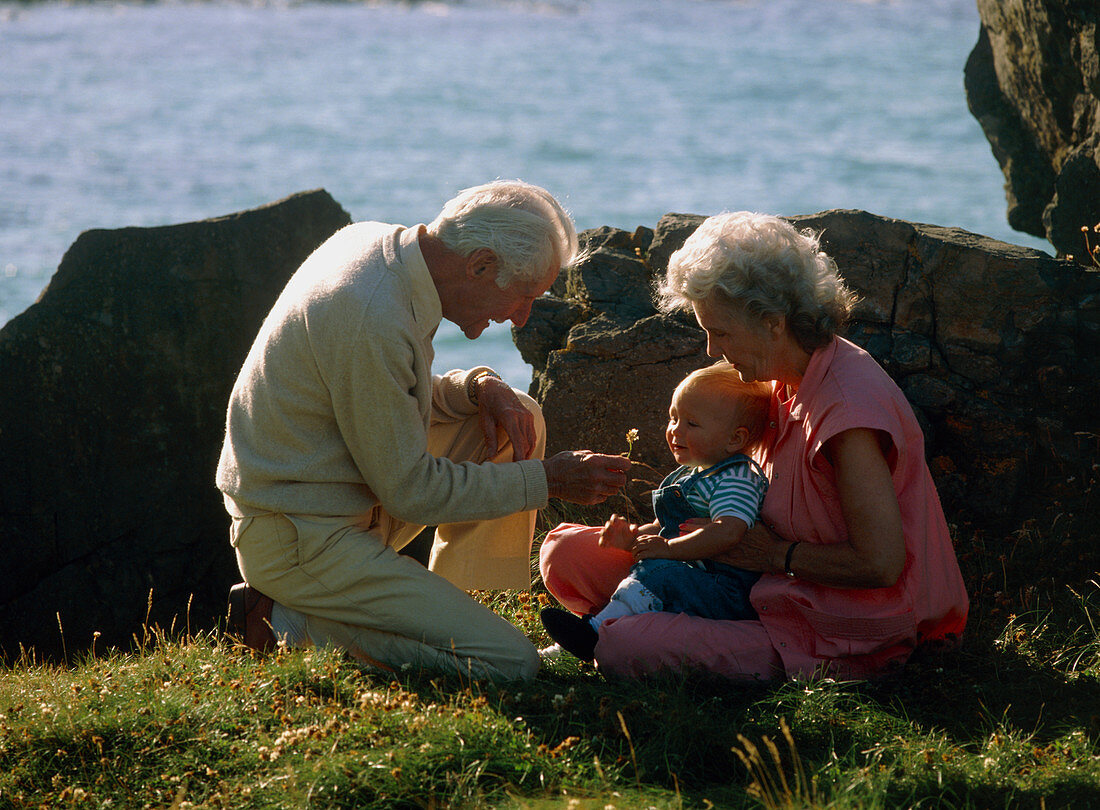 Elderly couple with grandchild at the coast