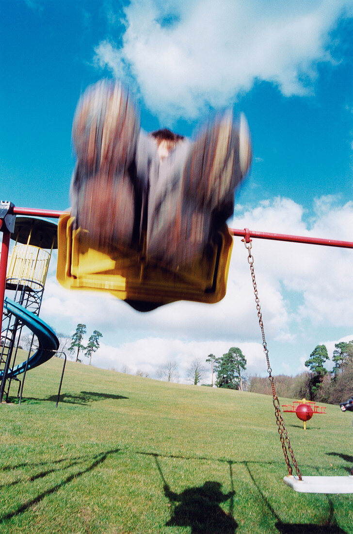 Child playing on a swing