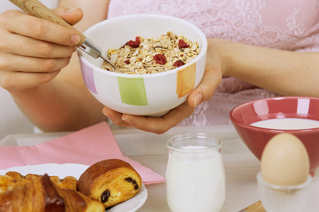 Woman holding bowl of cereal