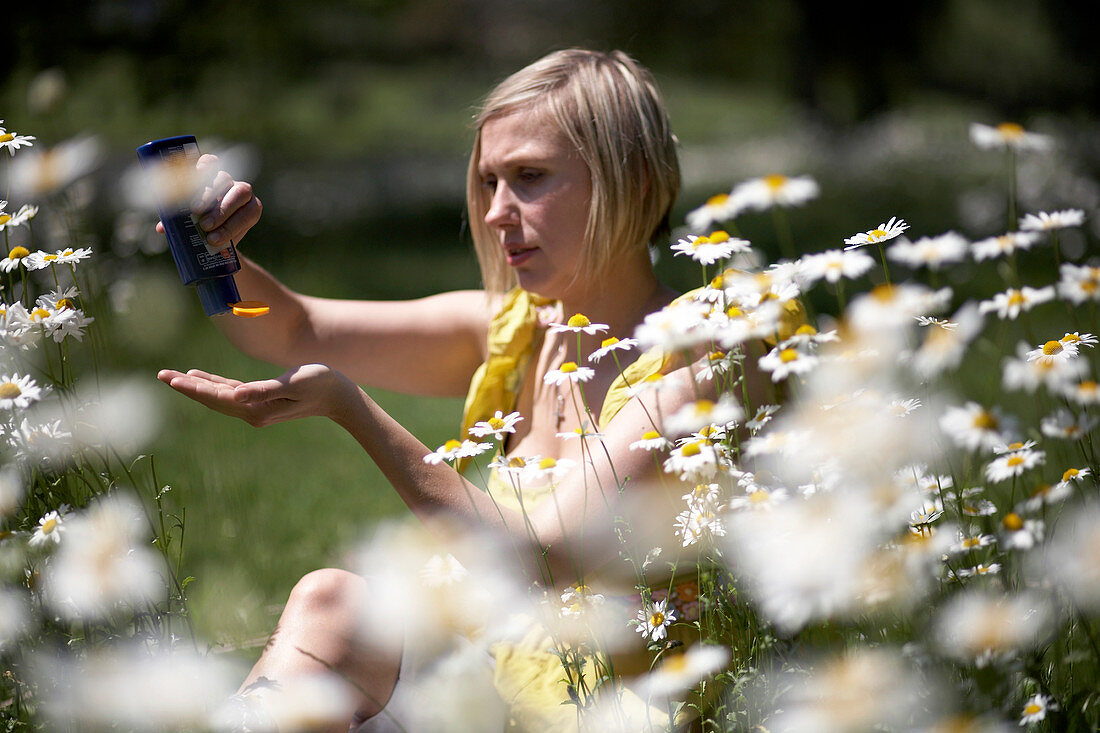 Woman applying suncream