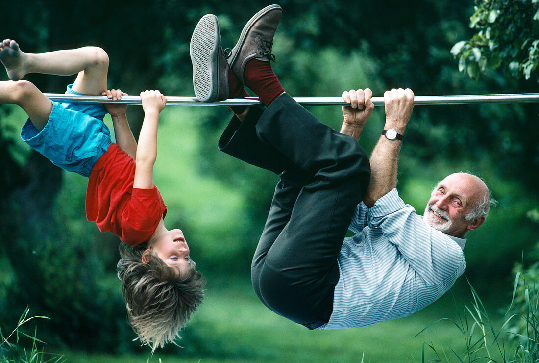 Elderly man and boy climbing