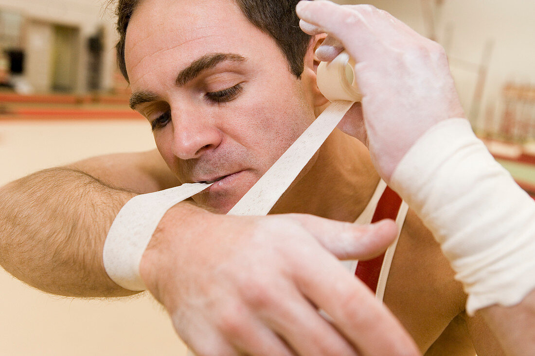 Gymnast taping up his wrist