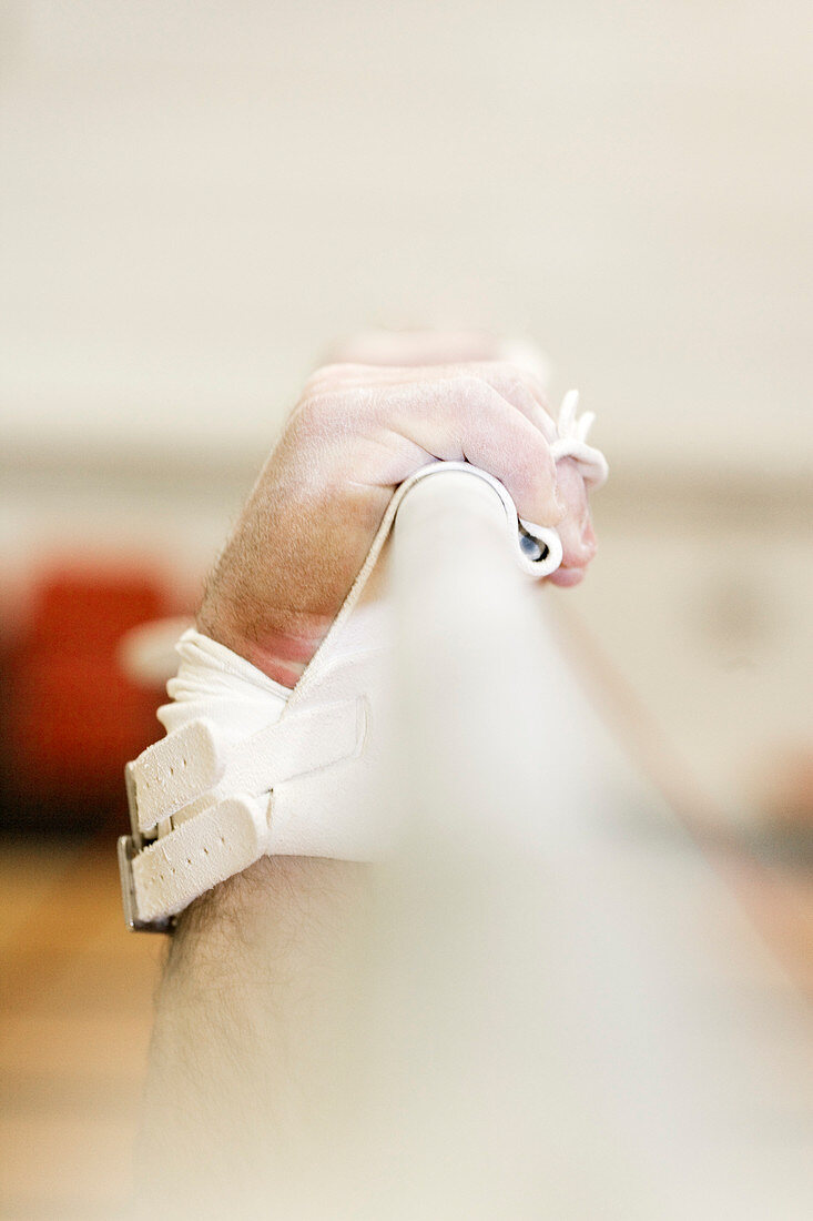 Gymnast's hands gripping a bar