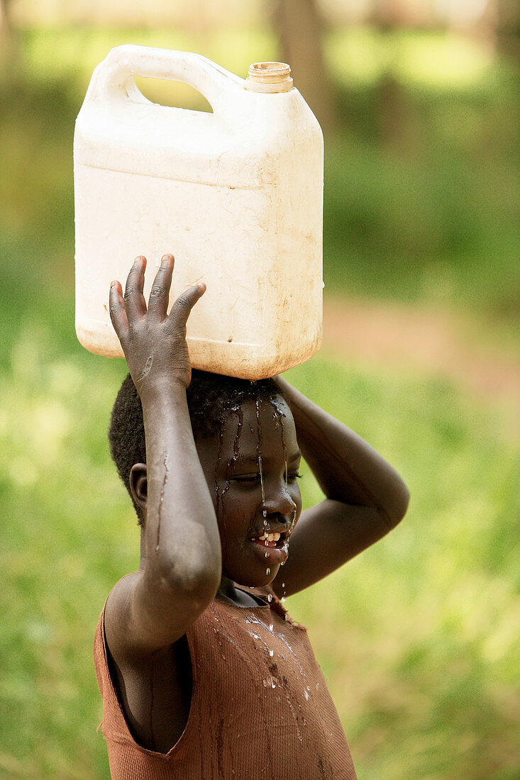 Ugandan child carrying water