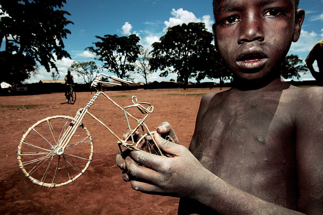 Boy holding a model bicycle,Uganda