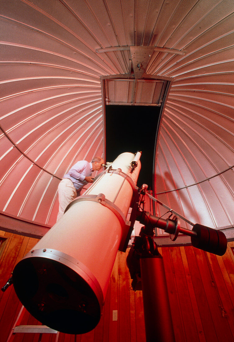Amateur astronomer uses a reflector telescope