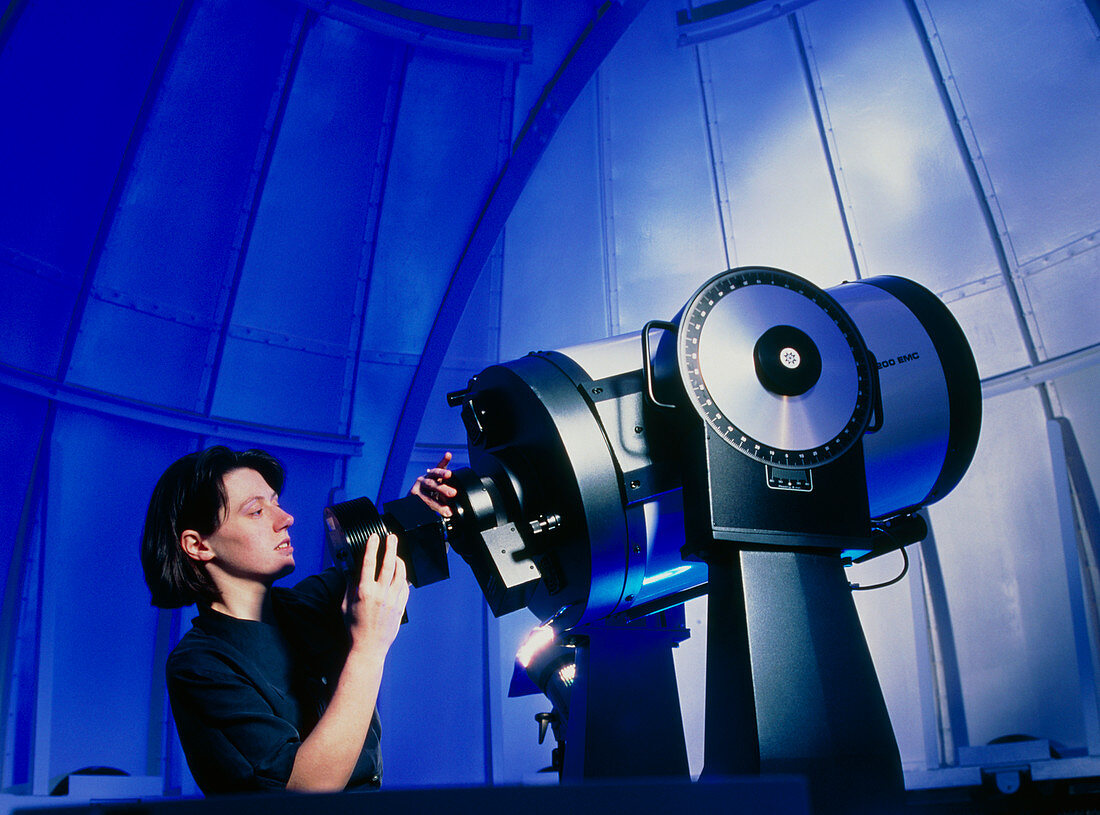 Astronomer operating an observatory telescope