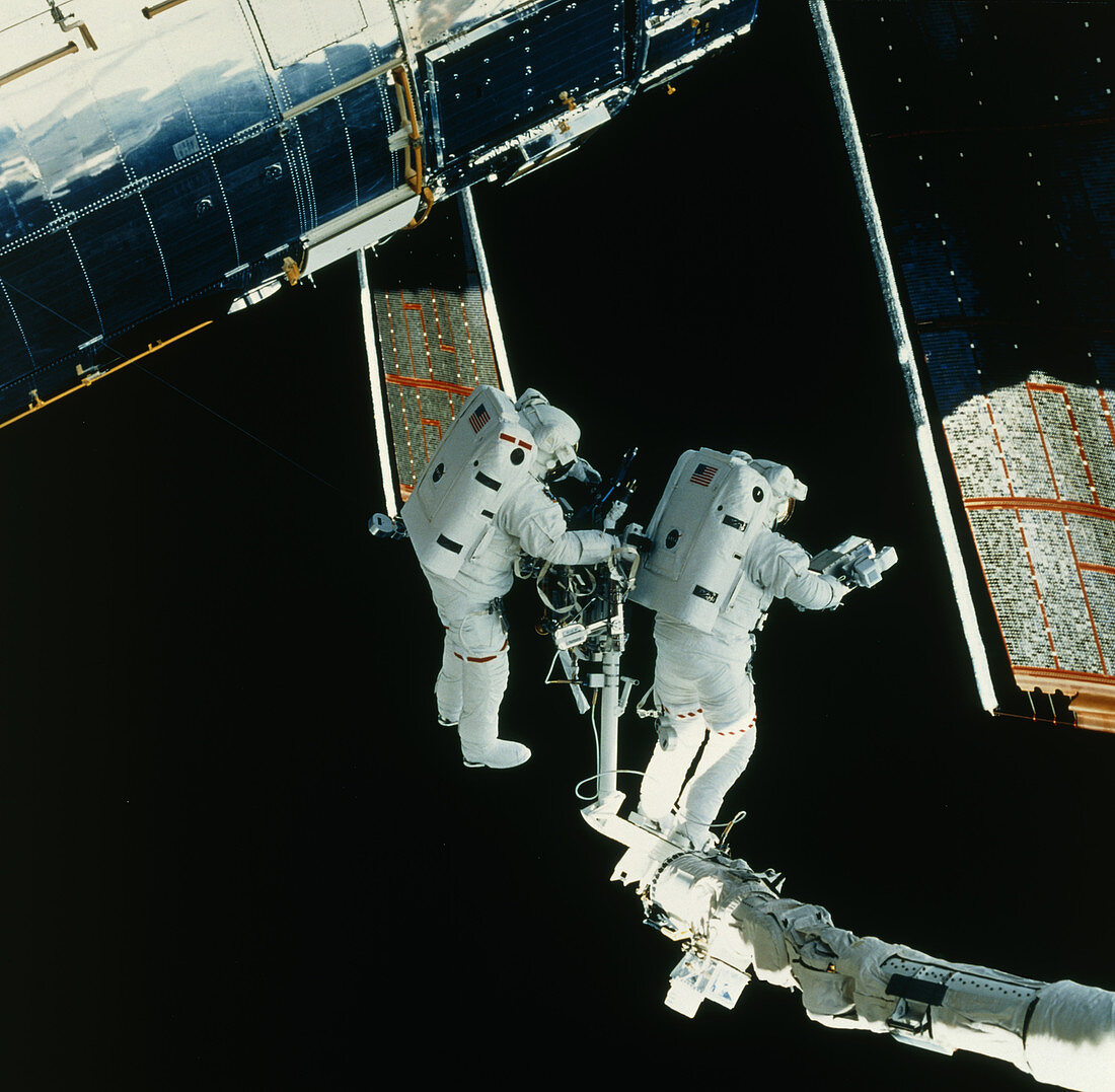 Astronauts repairing Hubble telescope