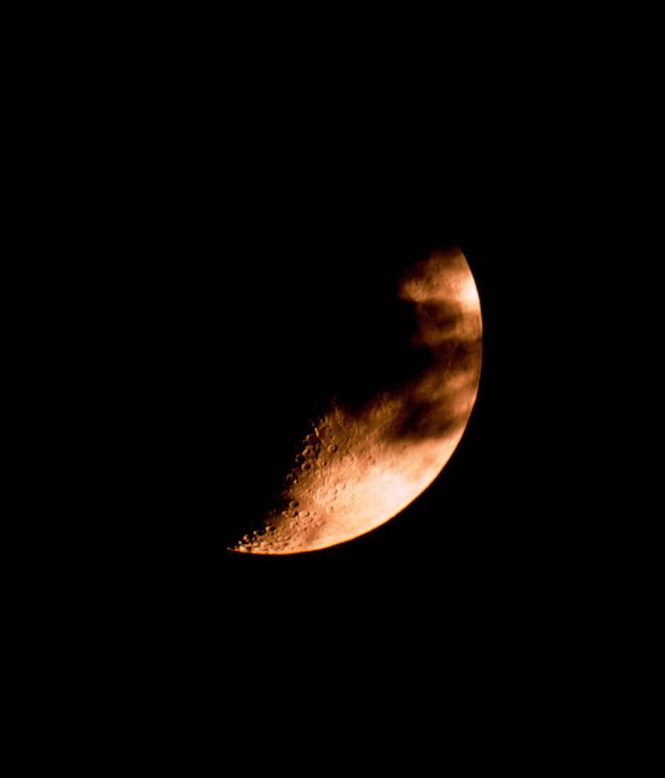 Cloud crossing a crescent Moon