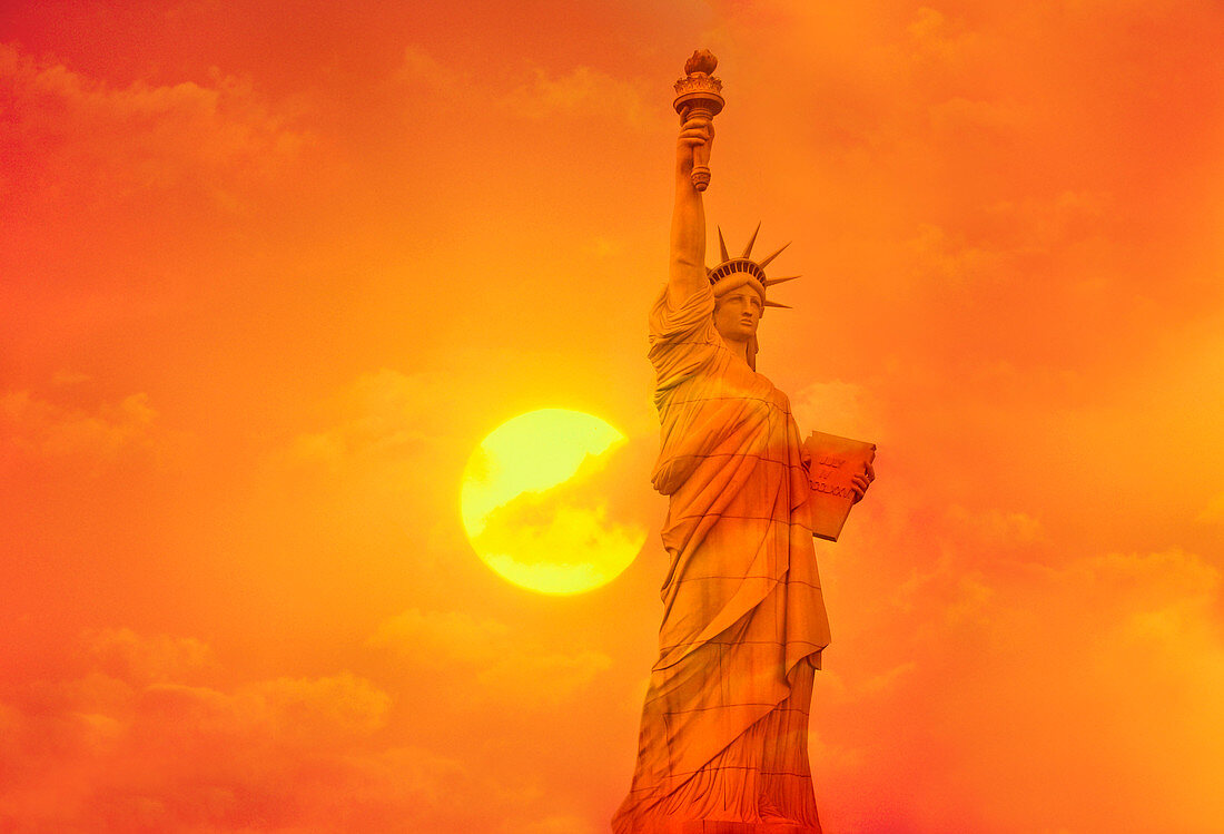 Sunset behind the Statue of Liberty
