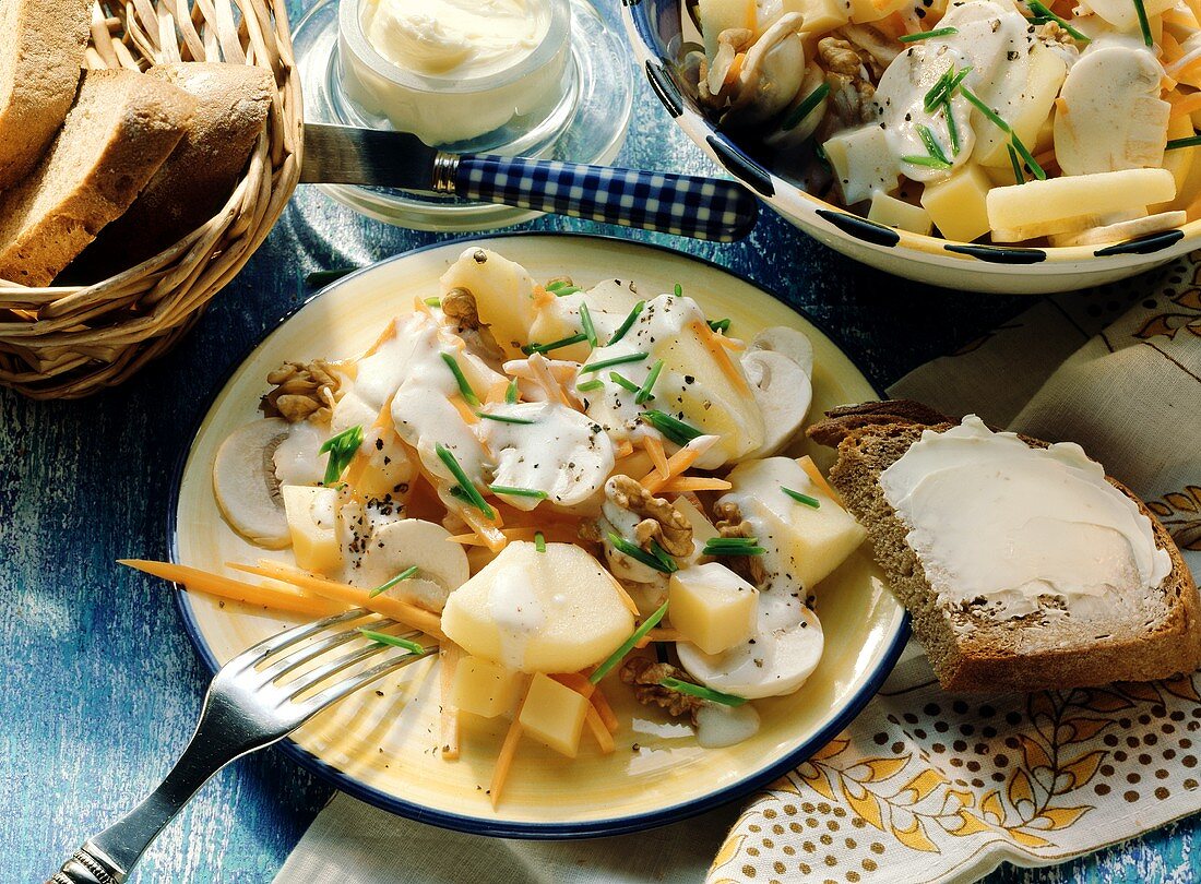 Potato salad with mushrooms, carrots, diced cheese and nuts