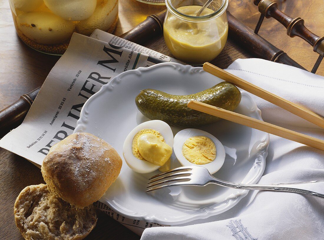 Pickled boiled eggs with mustard and gherkin